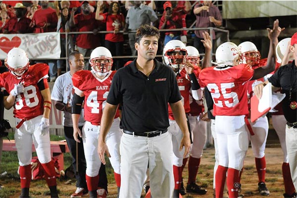 players and coach in a American football game