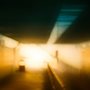 blurry impressionistic photo of light at the end of a dark tunnel