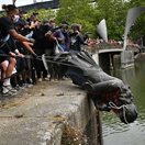 statue being dumped into a river