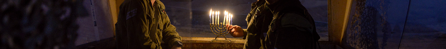 soldiers lighting a menorah