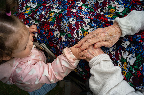 the hands of an old woman and a toddler