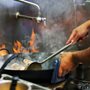 a man cooking over a fire