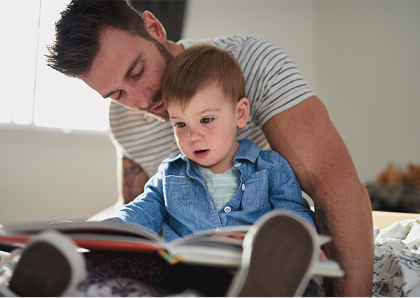 dad reading a book with his toddler