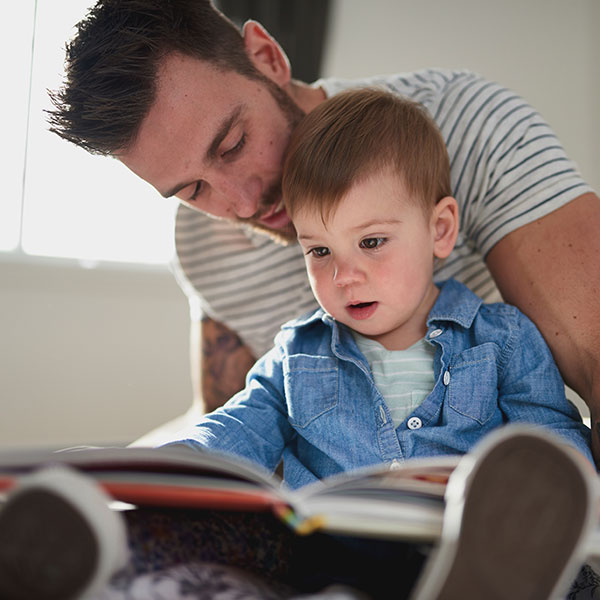dad reading a book with his toddler