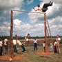 kids and adults at Koinonia playing on a swing set, 1940s or 50s