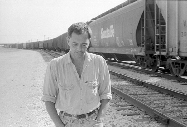 Rich Mullins walking next to a train