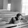 Rich Mullins in a church pew looking up
