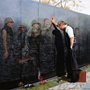 Reflections, painting by Lee Teter of a veteran at the Vietnam Memorial wall 