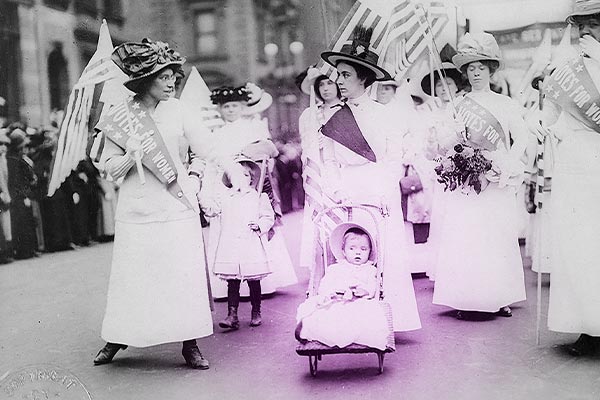 women lining up for parade; woman in front leading with baby and carriage, Suffrage parade, New York City, May 4, 1912