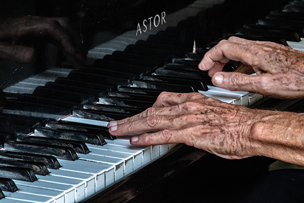 an old person playing the piano