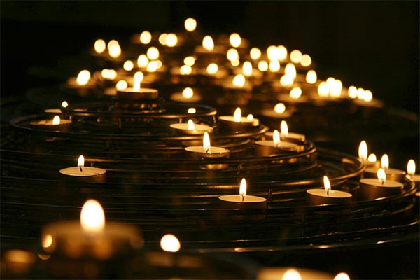 small votive candles on a tiered metal stand