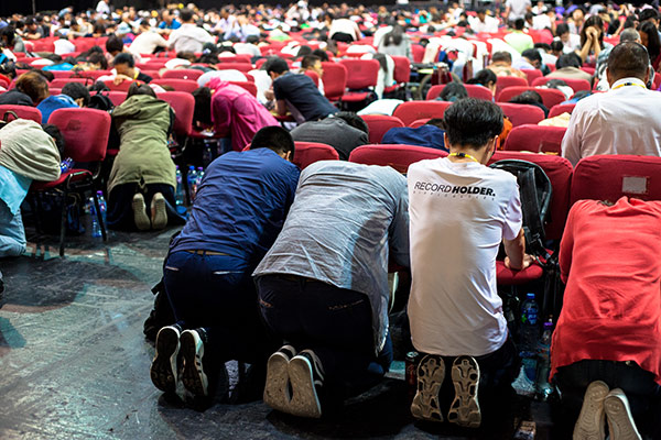 Chinese Christians praying at a conference