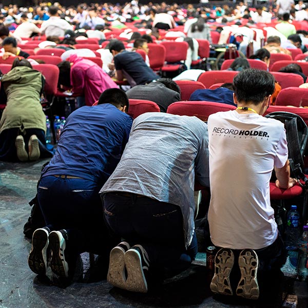 Chinese Christians praying at a conference