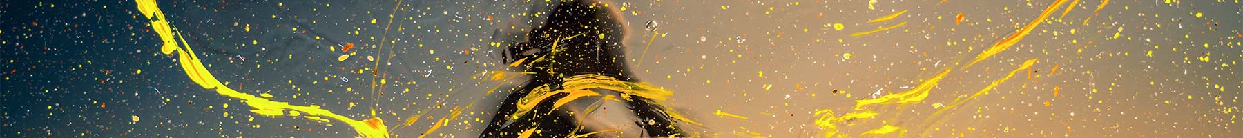 blurry photo of a woman splattered with yellow paint