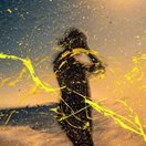 blurry photo of a woman splattered with yellow paint