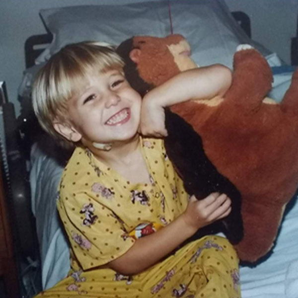 young boy in bed with a large stuffed animal