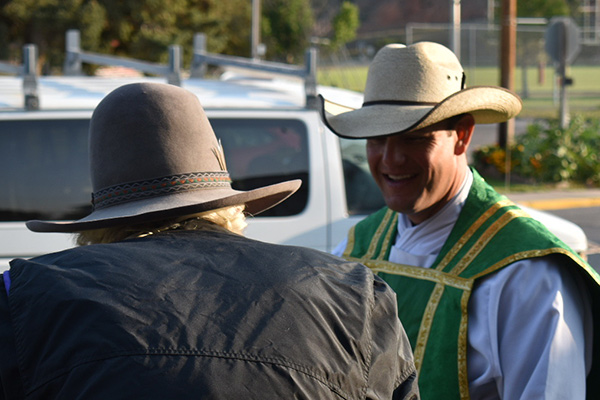 Father Bryce speaks with a parishioner