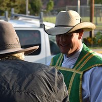 Father Bryce greeting a parishioner