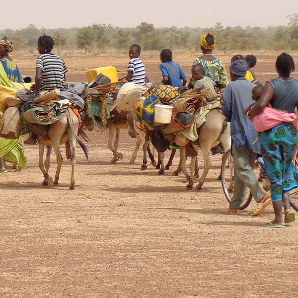 African refugees travelling over an arid landscape