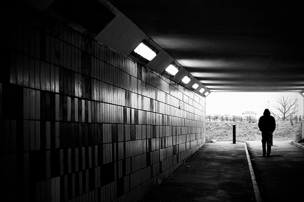 man walking through an underpass