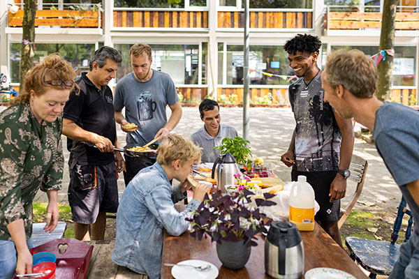 friends gathering at a table outdoors for a meal