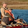 a young boy fishing with an old man