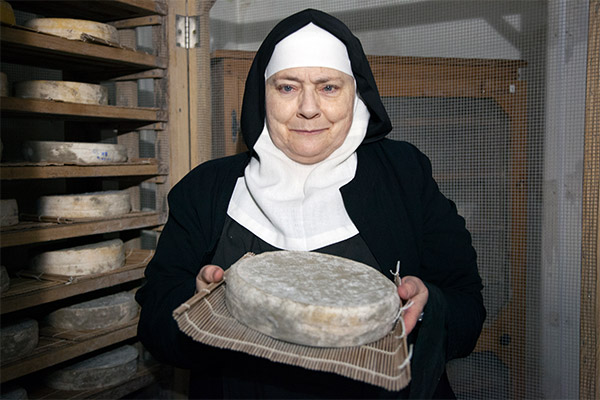 Mother Noella Marcellino holding a sample of her Bethlehem cheese in her cheese cave at the Abbey of Regina Laudis in rural Connecticut.