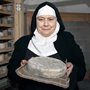 Mother Noella Marcellino holding a sample of her Bethlehem cheese in her cheese cave at the Abbey of Regina Laudis in rural Connecticut.