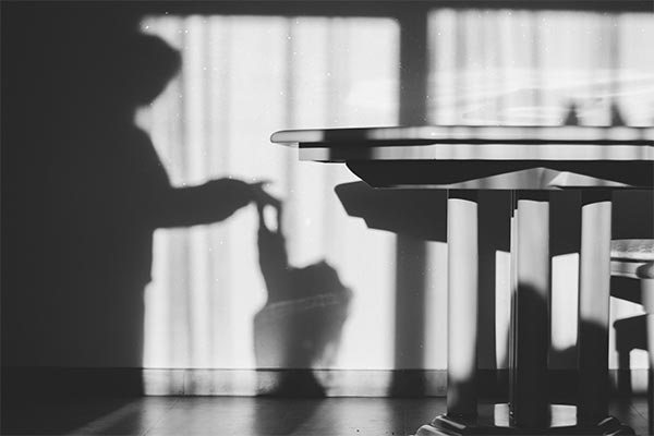 shadow of child and woman on a kitchen wall