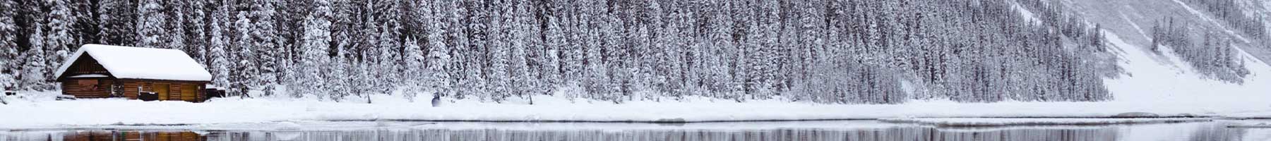 cabin near a mountain lake in winter