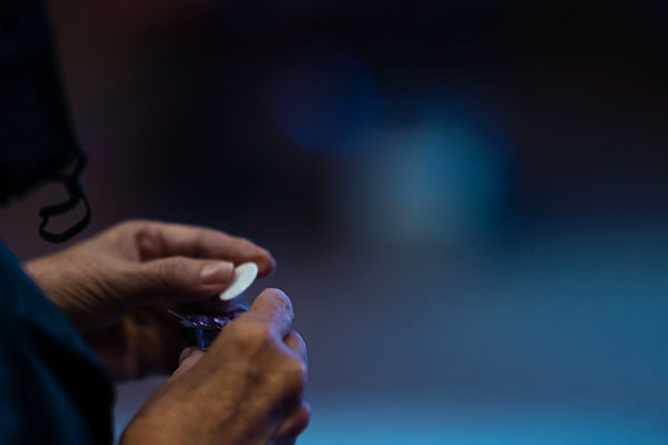 person holding a communion wafer