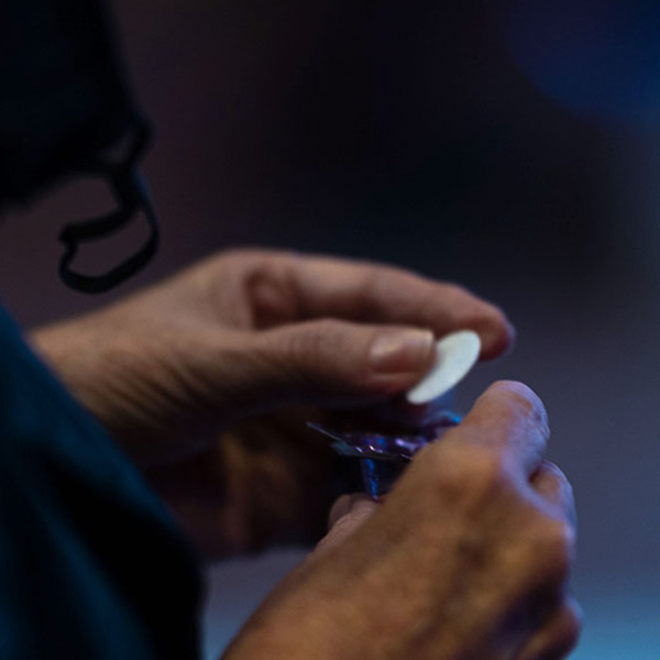 person holding a communion wafer