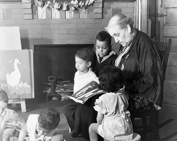 Jane Addams reading a storybook to children