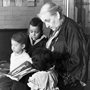 Jane Addams reading a storybook to children