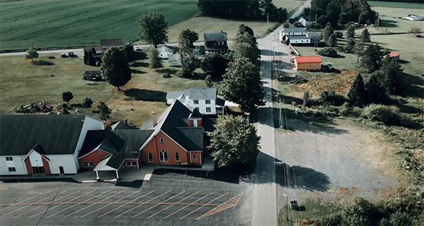 a rural  church surrounded by farmland