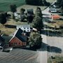 a rural  church surrounded by farmland
