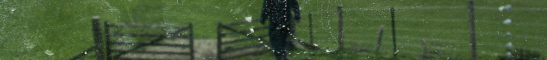 a farmer walking through a gate