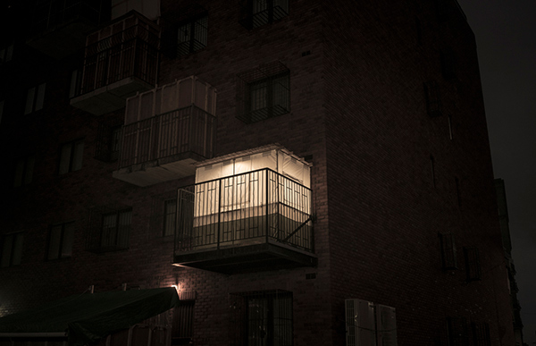 a Sukkah on a city balcony at night