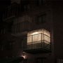 a Sukkah on a city balcony at night