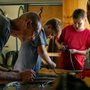 Man and boys repairing bicycles