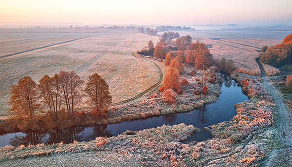 aerial view of farmland on a frosty morning