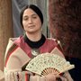 An Osage woman holding a fan