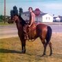 a young woman riding a chestnut horse