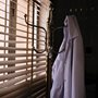 a lab coat hanging by a window