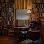 a room with bookshelves and a comfortable recliner