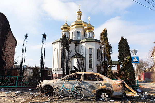 Damaged church and burned car in Irpin, Ukraine