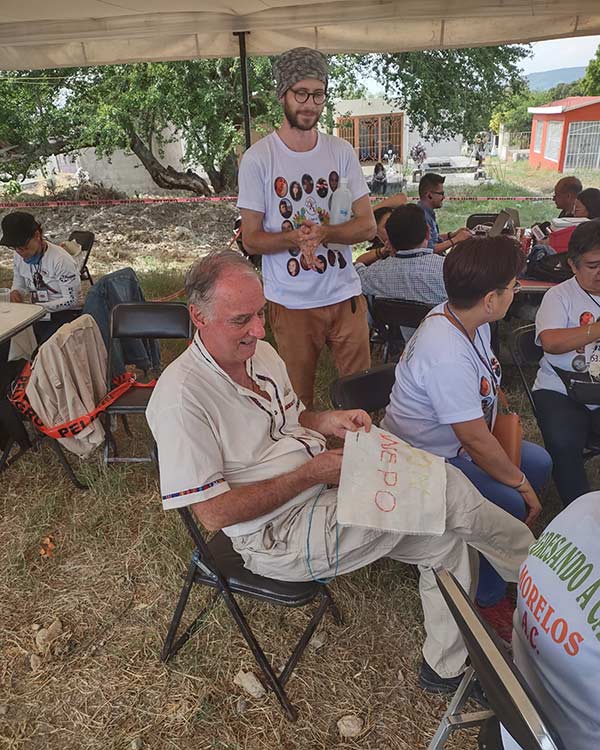 Pietro Ameglio embroiders the name of a disappeared person on cloth.