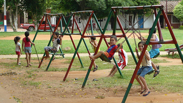 Paraguayan children on swings in park