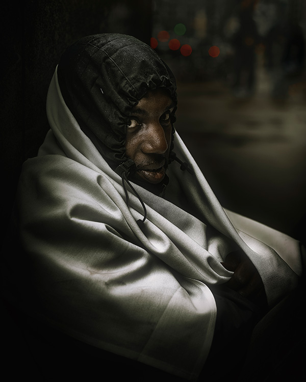homeless man wrapped in a blanket