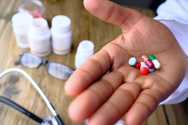 a doctors hand holding pills